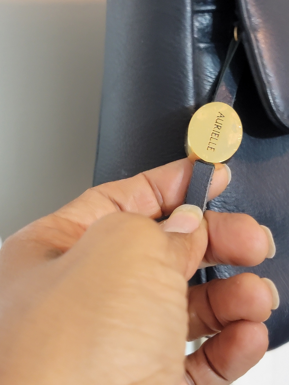 Aurielle Black Leather Shoulder Bag with Gold Tag